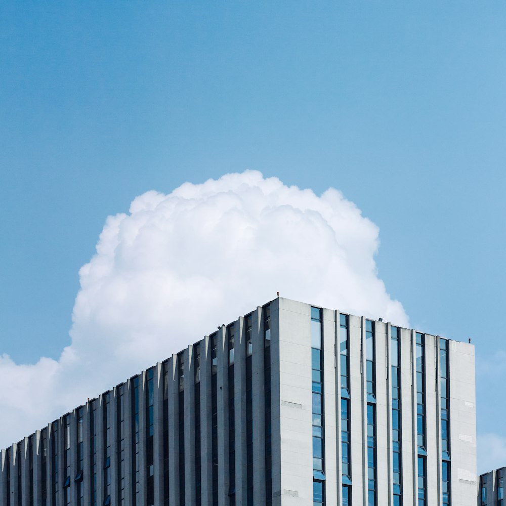 a tall building with a cloud in the sky