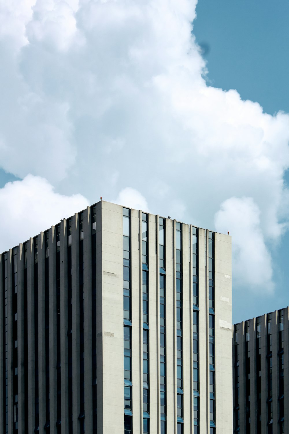 a tall building with a cloudy sky