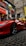 A satisfied customer standing next to a shiny Ferrari.
