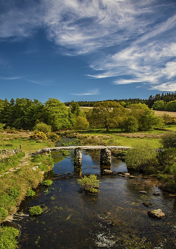 a small river with a bridge