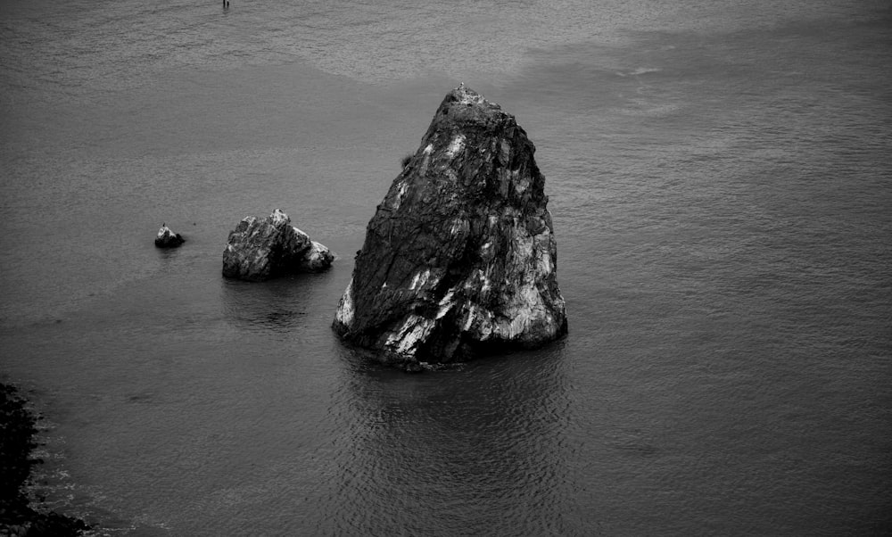 a group of large rocks in the water