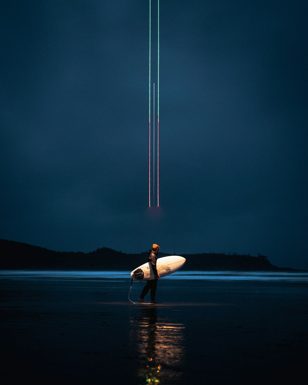 a person carrying a surfboard on the beach