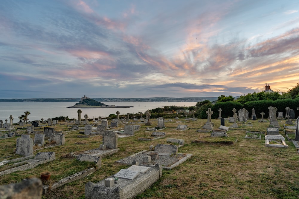 a cemetery with a body of water in the background