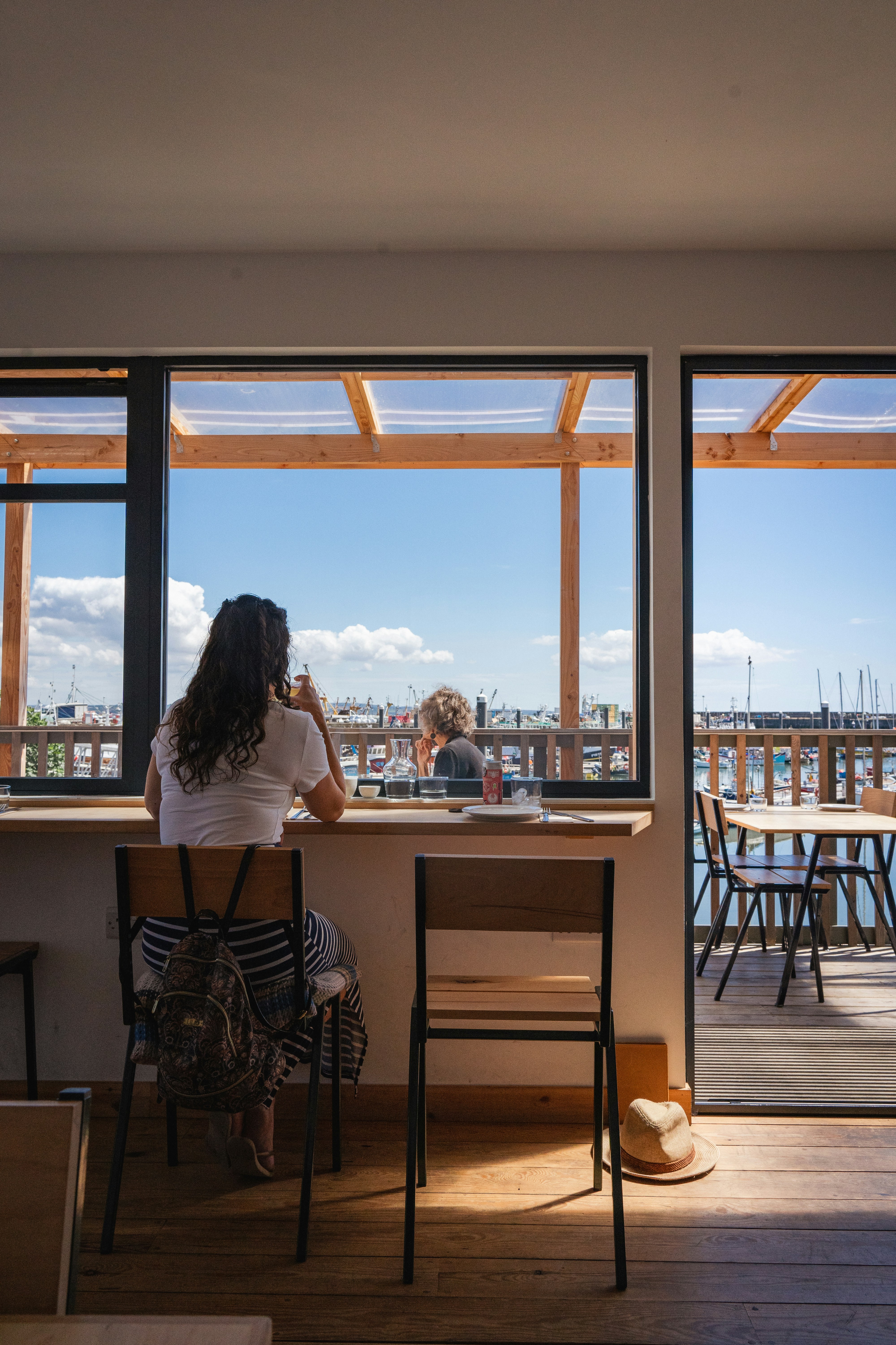 a group of people sitting at a table looking out a window