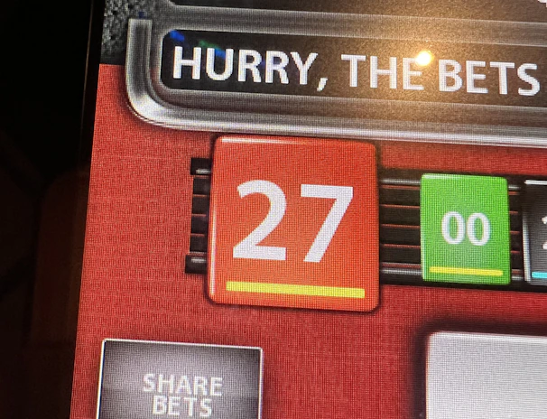 Excited player holding phone showing free spin bonus round in online casino