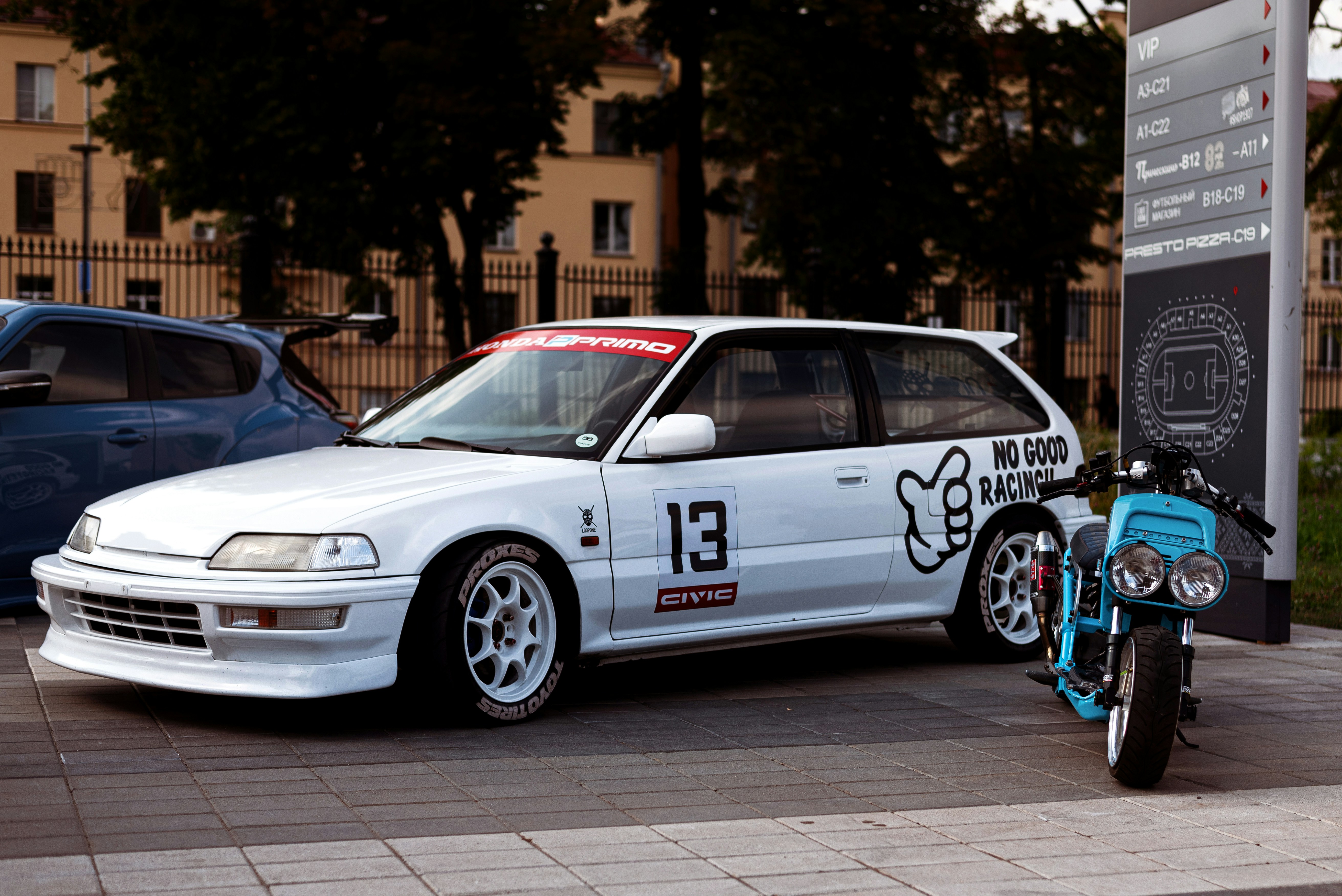 a white car with a bike on the front
