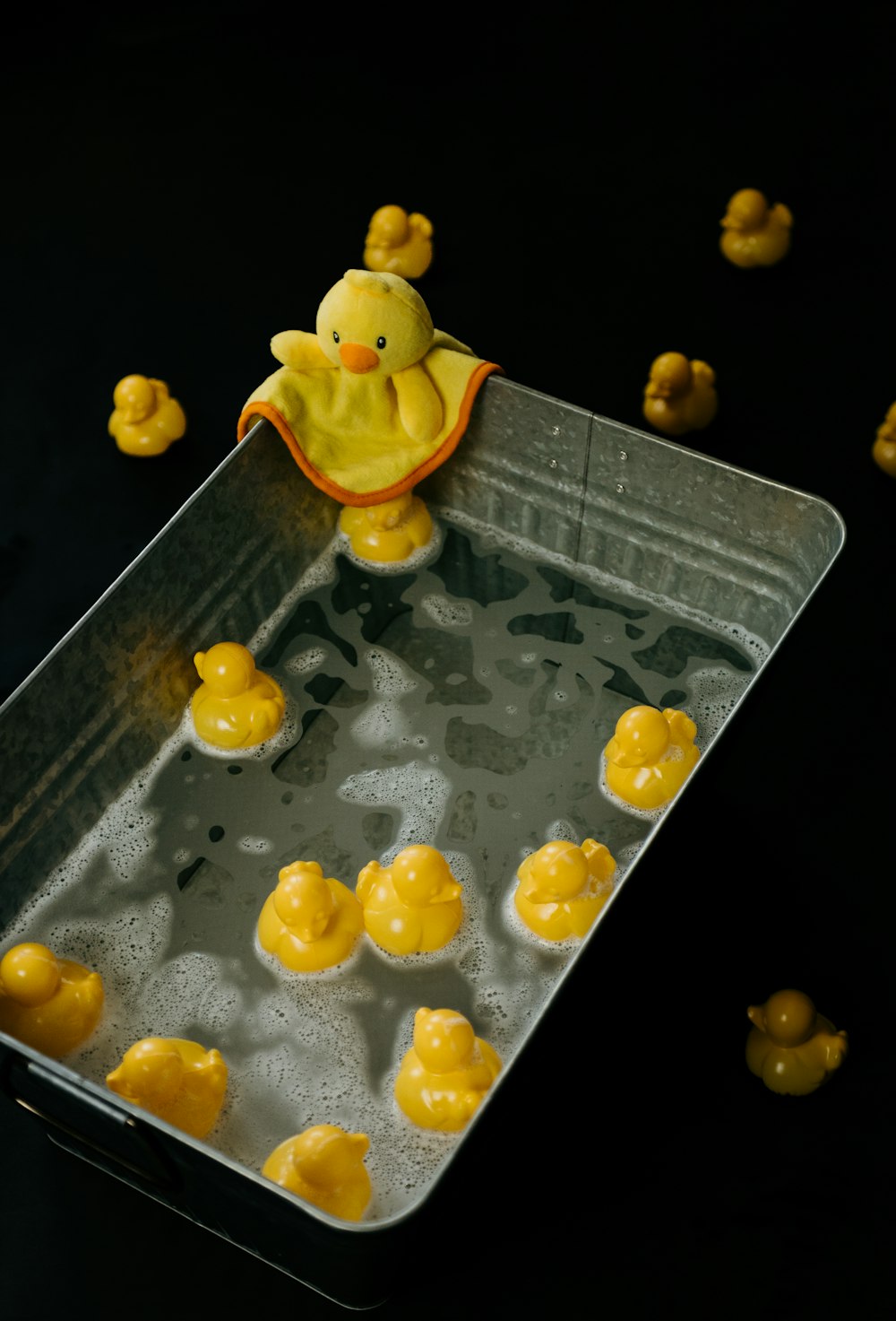 a yellow rubber ducky on a black surface