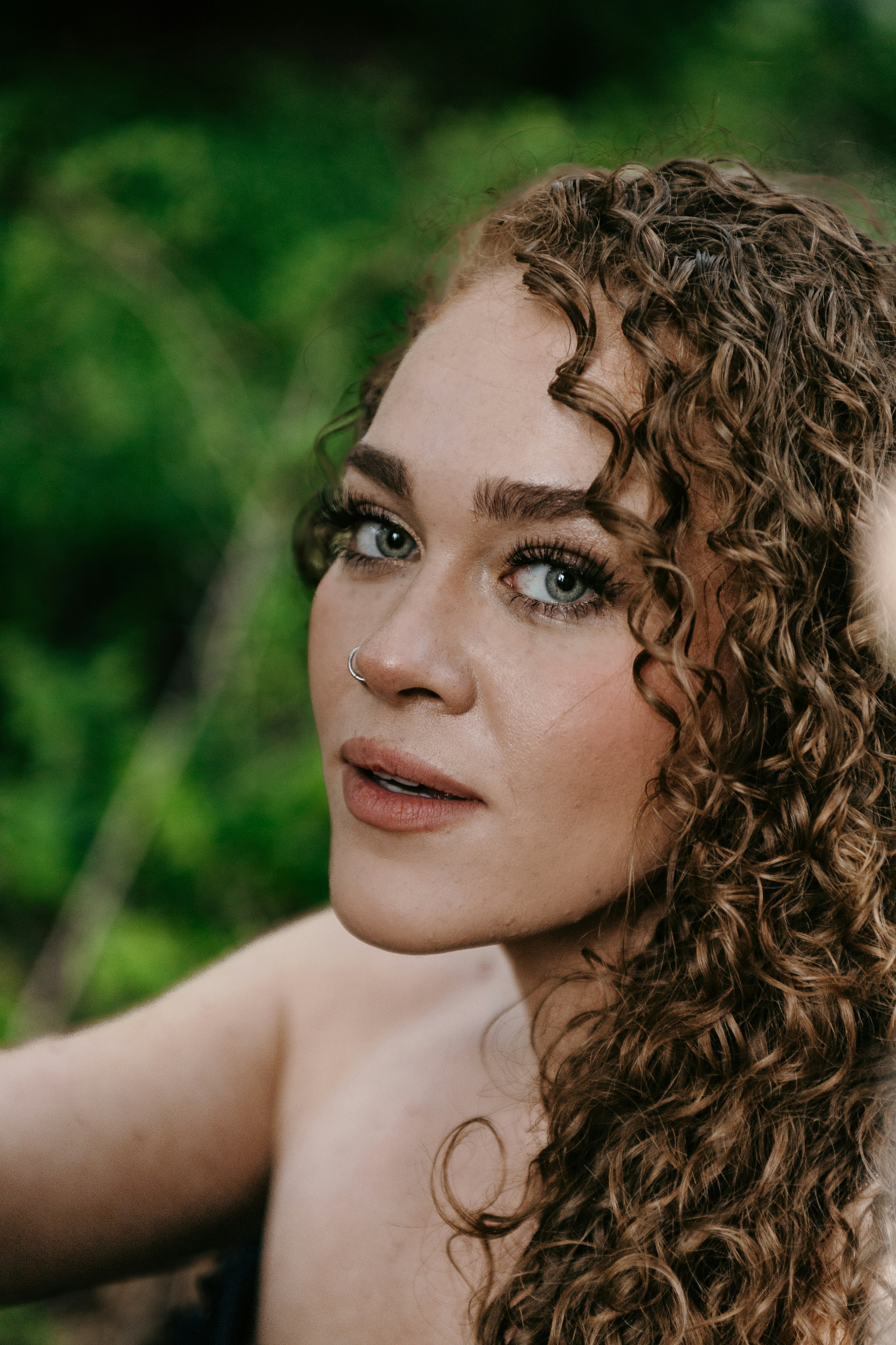 Defined curls illustrate healthy texture and softness rather than over-styling