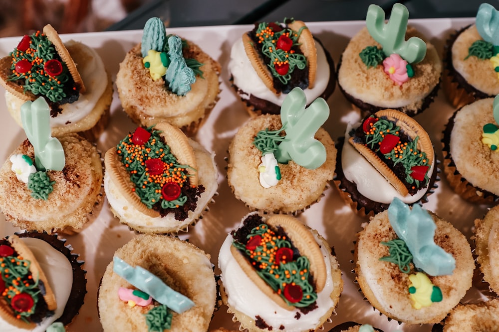 a group of cupcakes with frosting and decorations