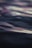 Abstract waves of light and sound flowing harmoniously over a calm, dark background.