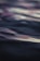 Abstract waves of light and sound flowing harmoniously over a calm, dark background.