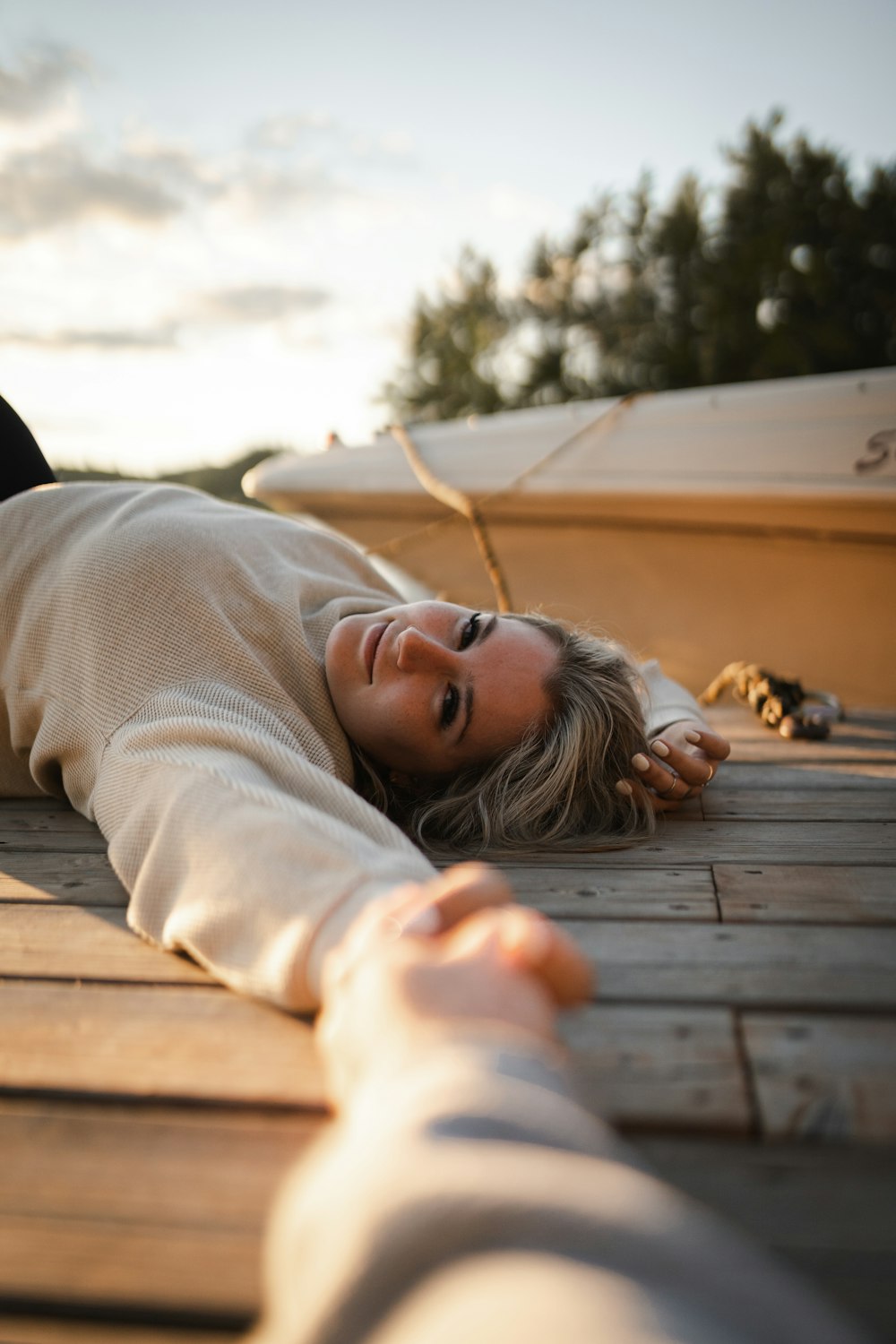 a person lying on a wooden deck
