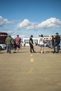 A group of plot owners gathered in a community meeting under a bright sky in Thiruporur.