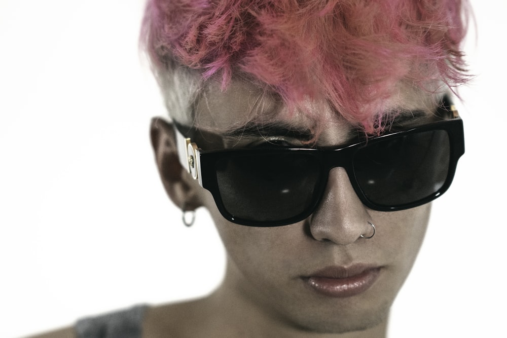 a man with pink hair and sunglasses