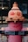 A painted fire hydrant with human-like features, including red eyes and a smile, stands out on the sidewalk. It is marked with a sign reading 'METRO WATER SERVICES'.