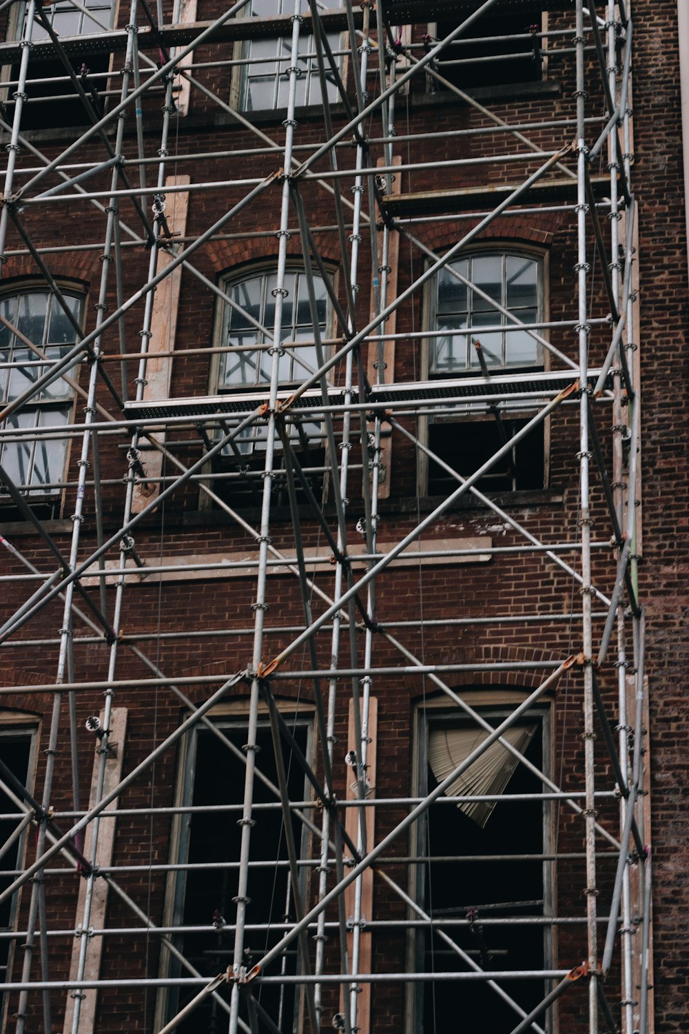 a brick building with windows with Centre Georges Pompidou in the background