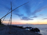Sunset over the Niger River with fishermen in wooden boats.