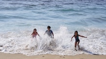 Children playing happily at the beach house in Lewes, Delaware, supported by paddleboard sales.