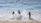 A joyful family playing together on a sunny beach vacation.