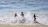 A joyful family playing together on a sunny beach vacation.