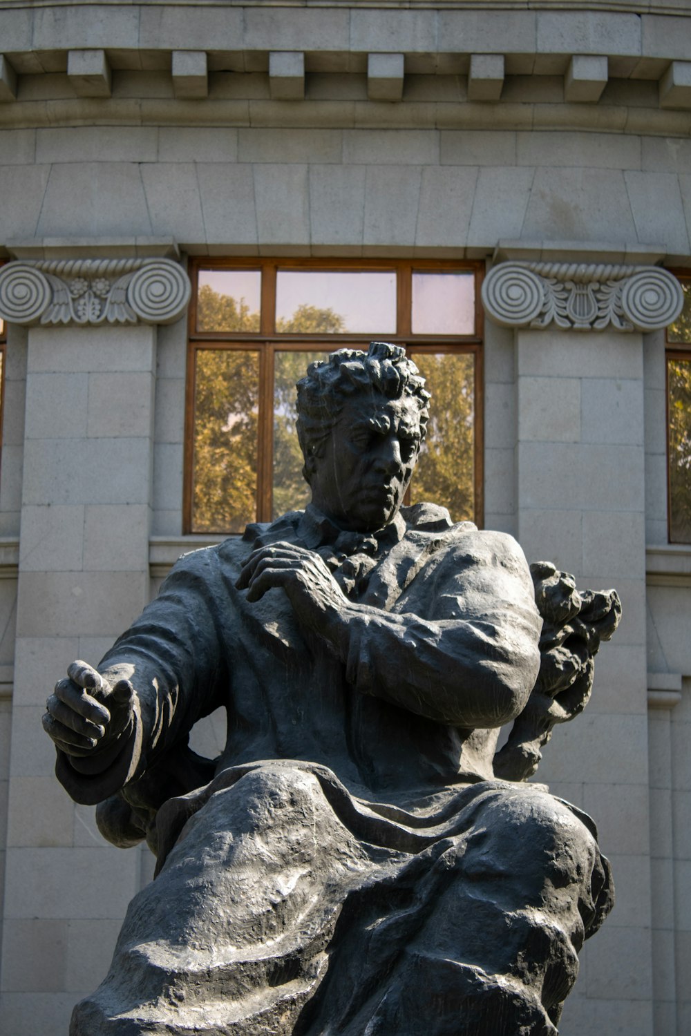 a statue of a person holding a book