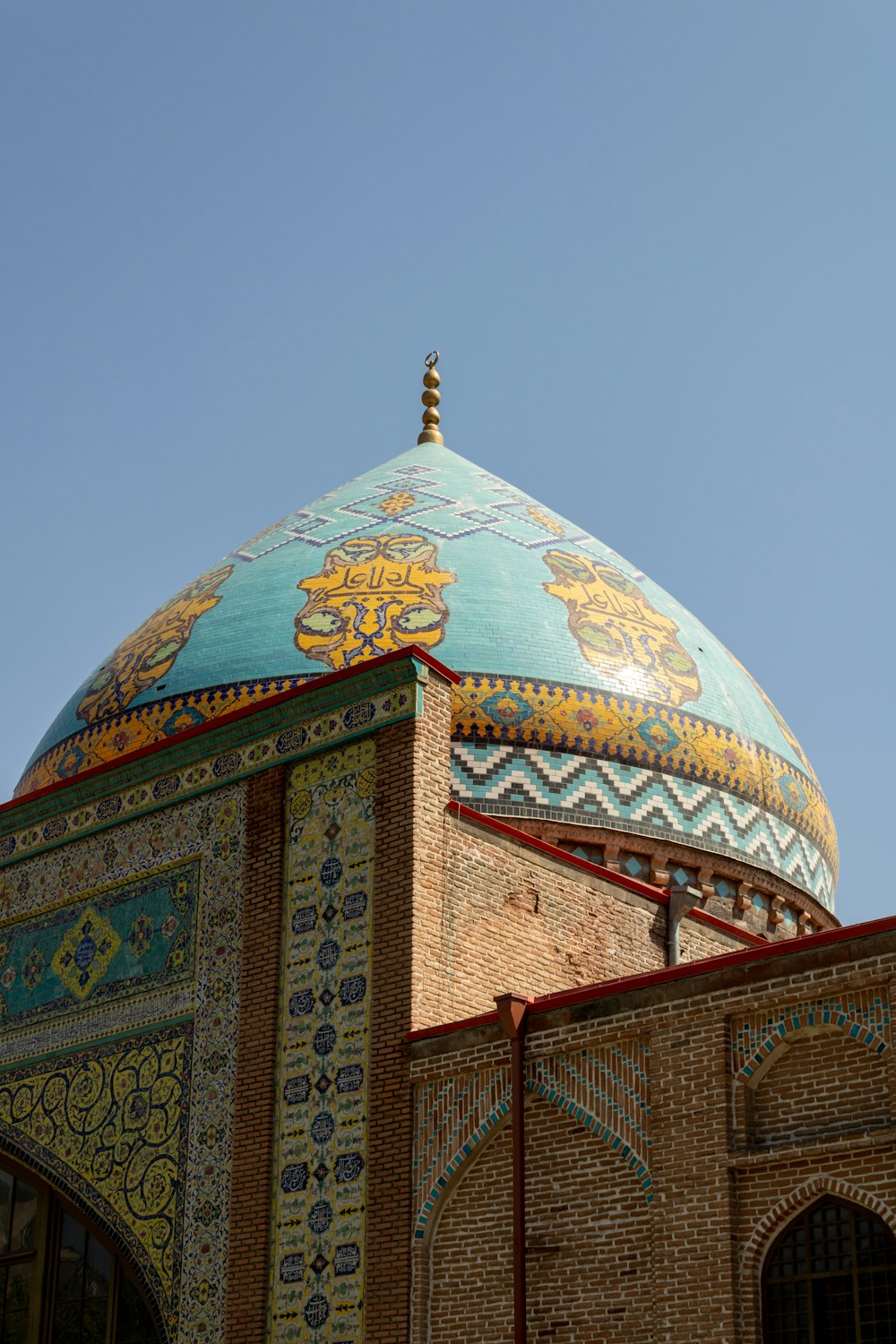 a colorful building with a gold roof