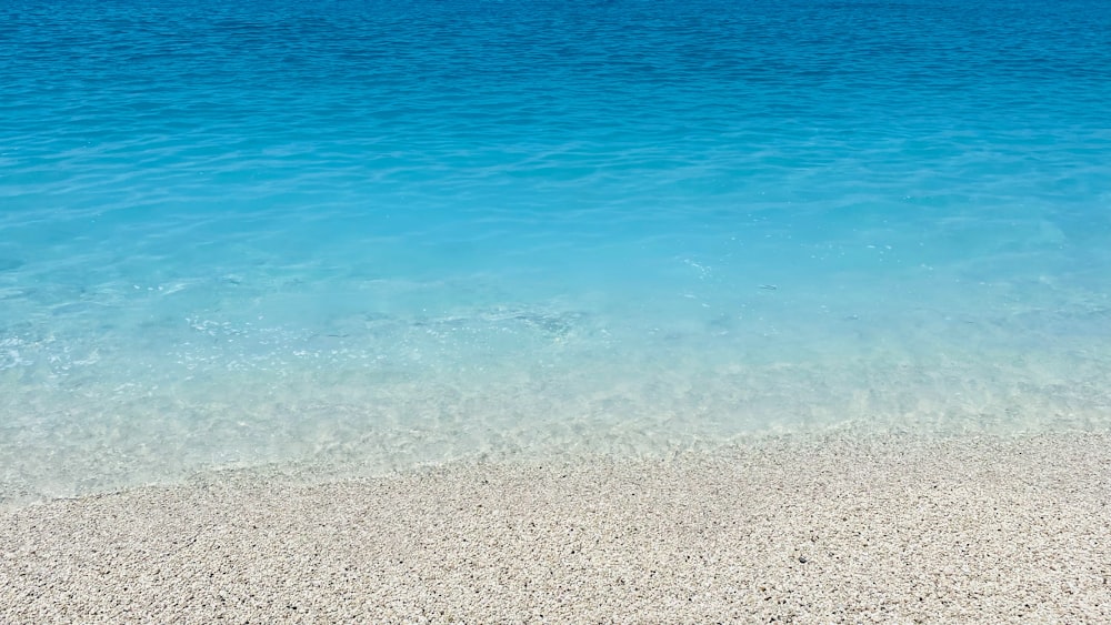 a beach with clear blue water
