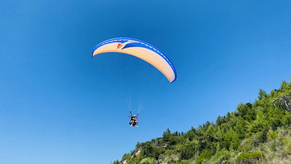 a person in the air with a parachute