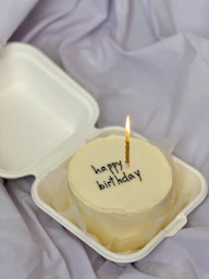 a candle in a yellow candle holder