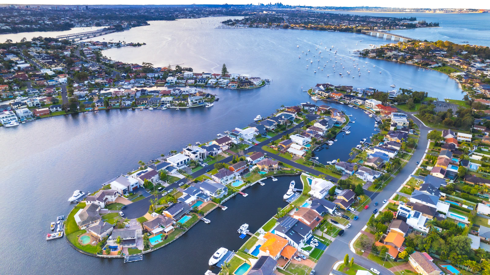 Drone photo of a waterfront canal estate with location labels