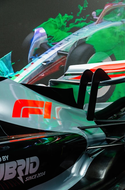 Sleek car silhouette with glossy highlights and electric blue accents on a dark carbon fiber background.