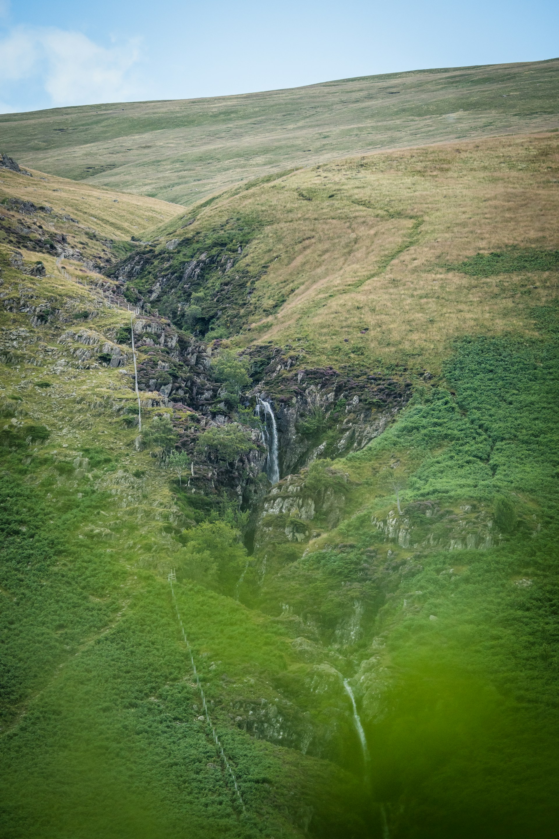 woman wearing yellow long-sleeved dress under white clouds and blue sky during daytime
