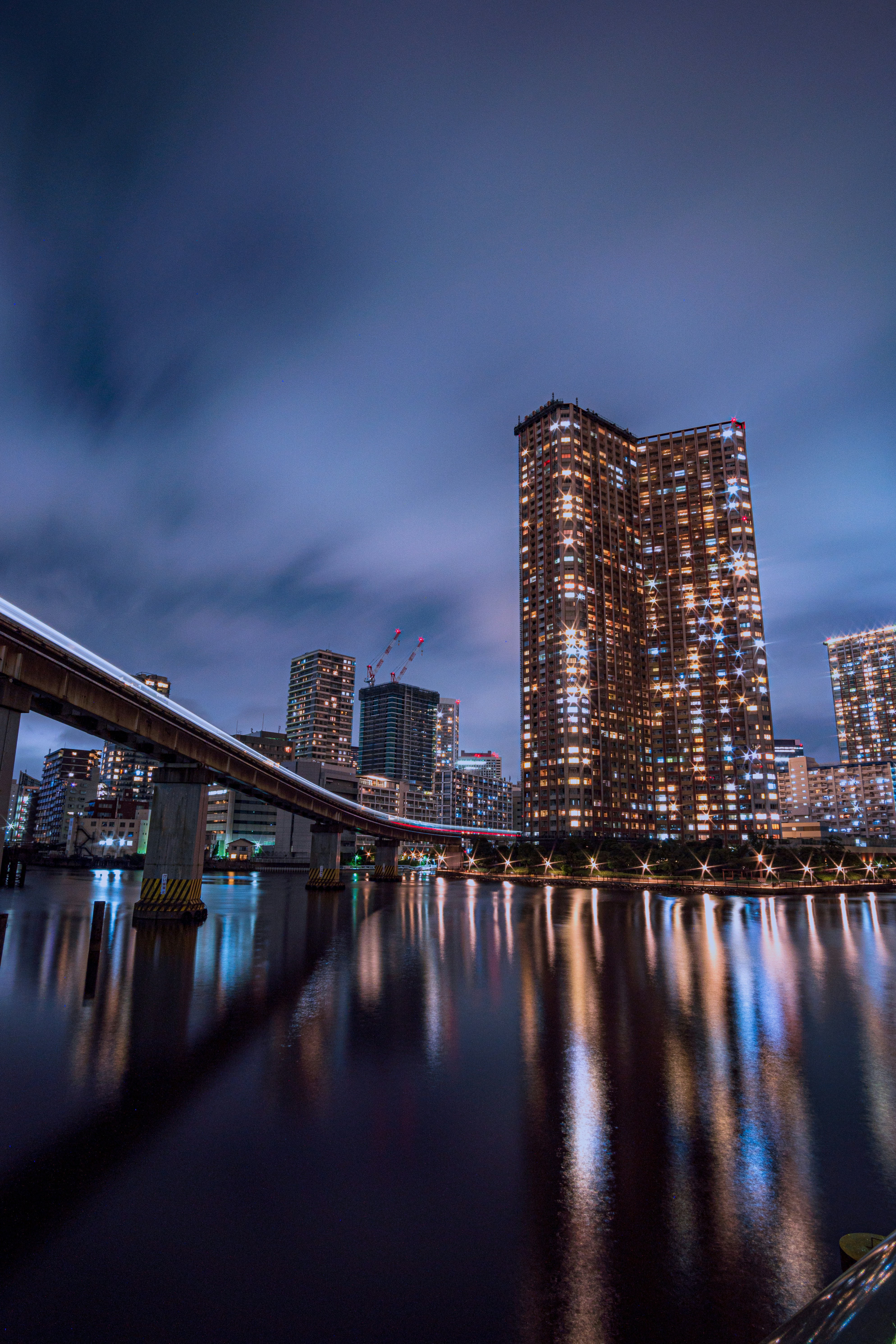 A bridge over water with buildings in the background photo – Free ...