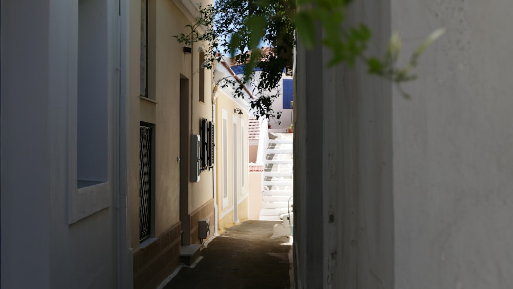a narrow alley way with white doors