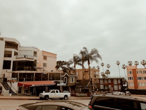 Modern storefronts and restaurants along a busy coastal street
