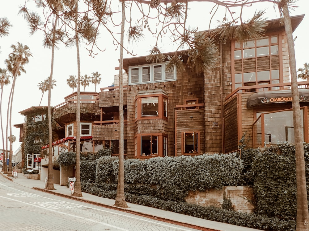 a building with palm trees and bushes