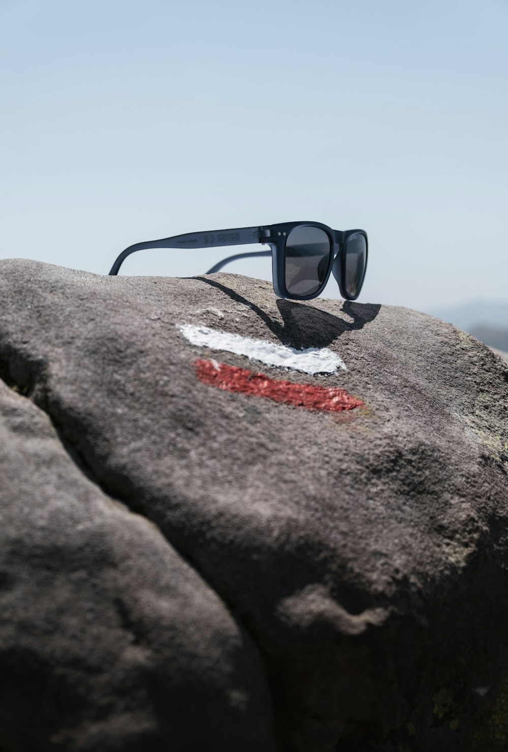 a pair of sunglasses on a rock