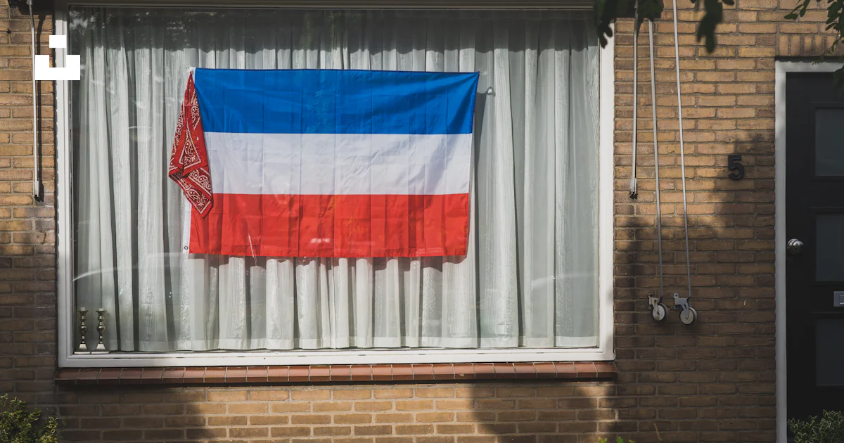 Flag In Window A flag on a window photo – Free Zuidland Image on Unsplash