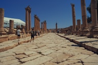 An ancient stone city street bathed in warm afternoon light, inviting exploration.