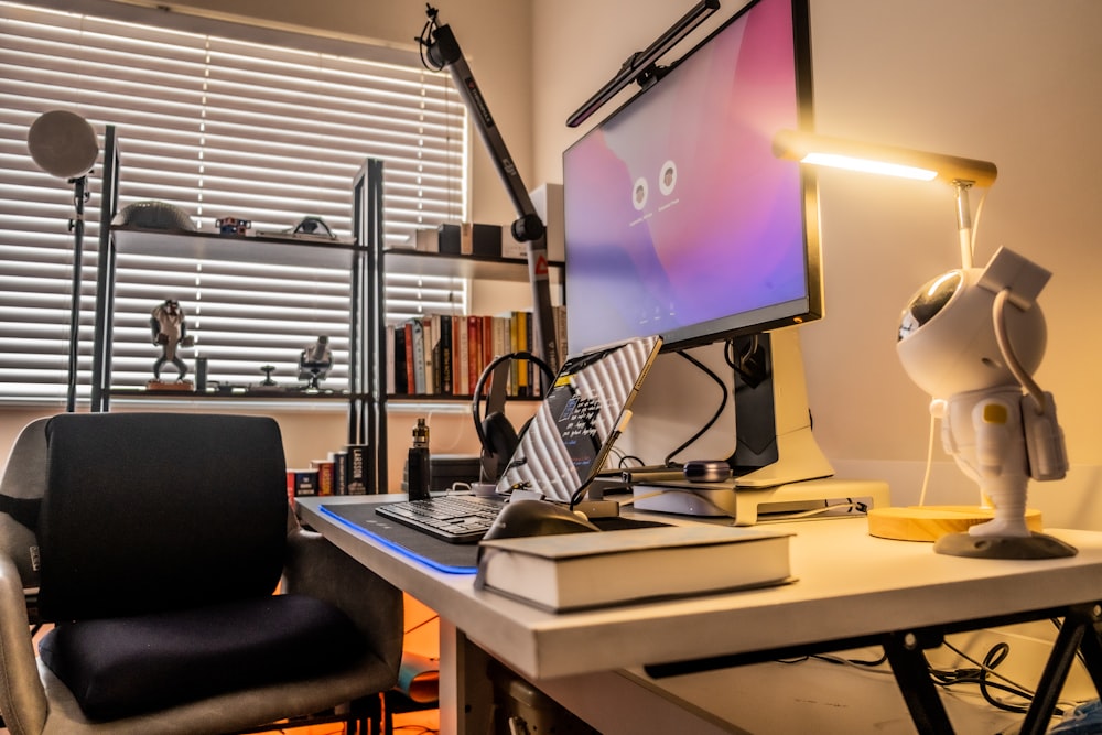 a desk with a computer and a chair