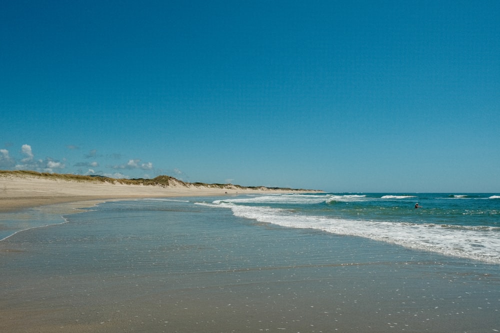 a beach with waves crashing on it