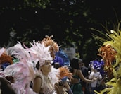 A vibrant festival scene with people in traditional Carinal costumes dancing joyfully.