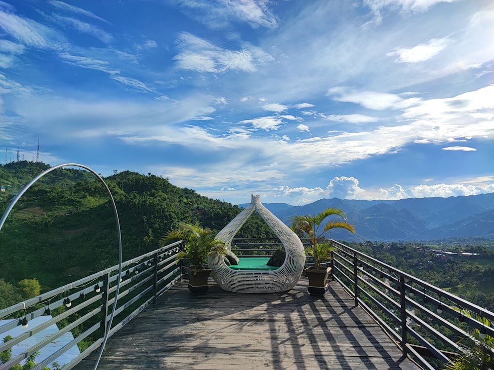 a deck with a boat on it and trees and mountains in the background