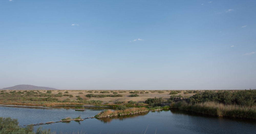 a body of water with land in the back