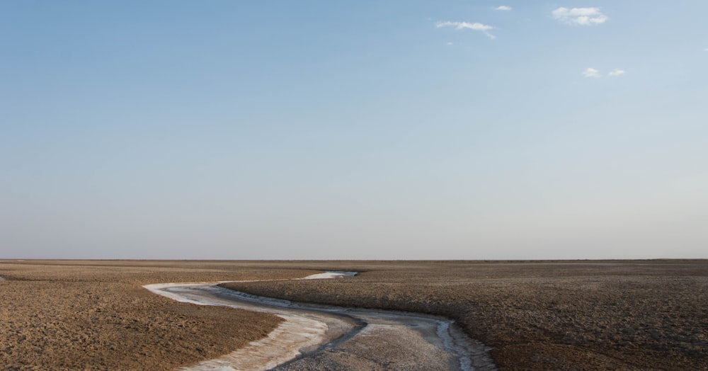 a large flat area with a puddle in it