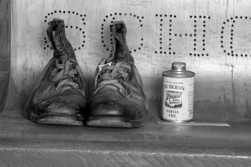 a pair of boots next to a can