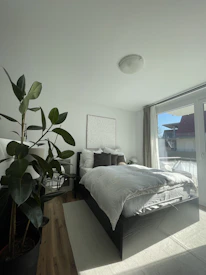 Bright and spacious bedroom with soft linens and a peaceful atmosphere.