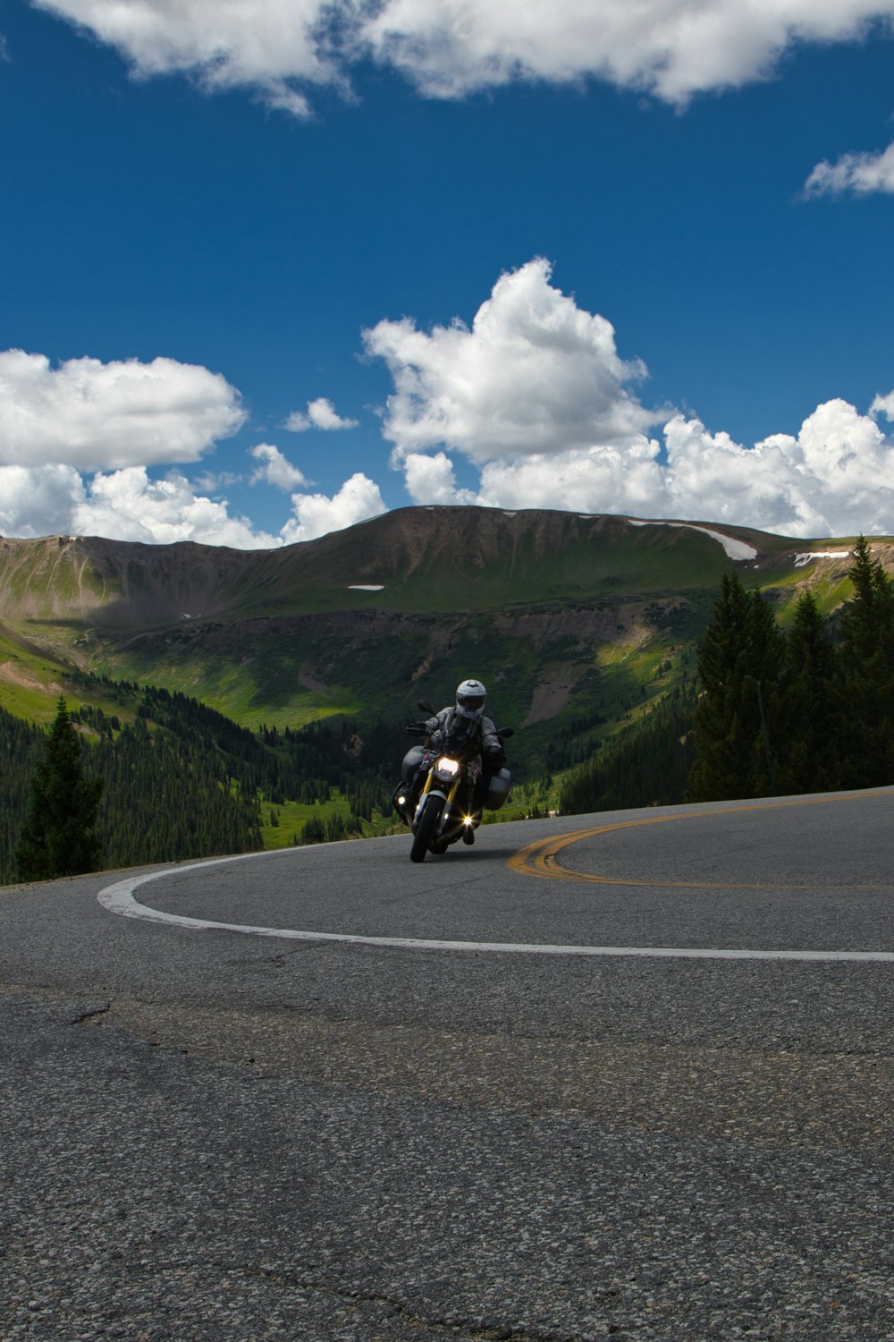 a man riding a motorcycle on a road