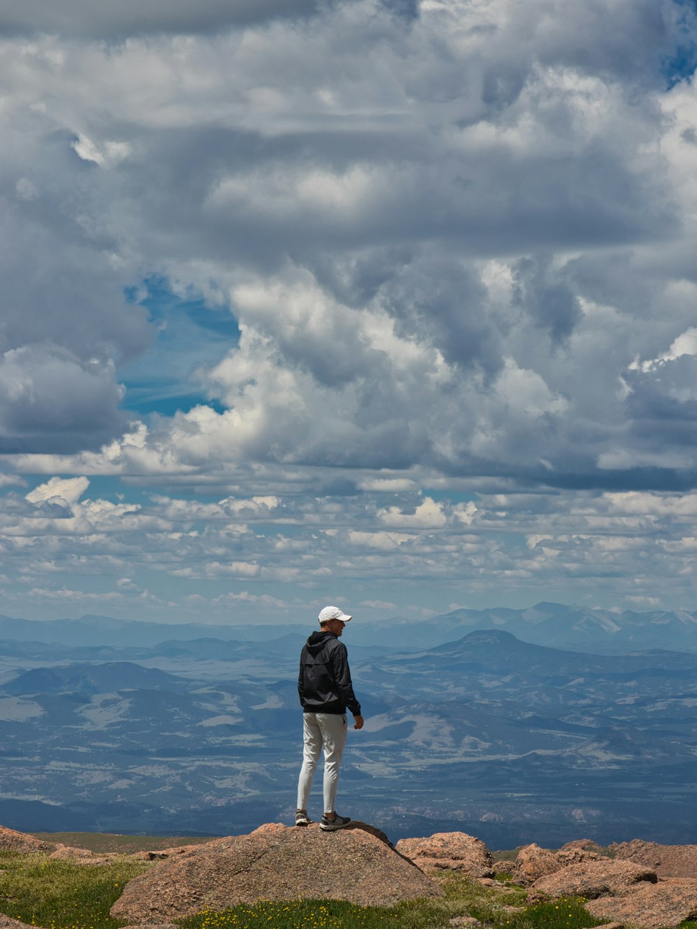 a person standing on a rock overlooking a body of water