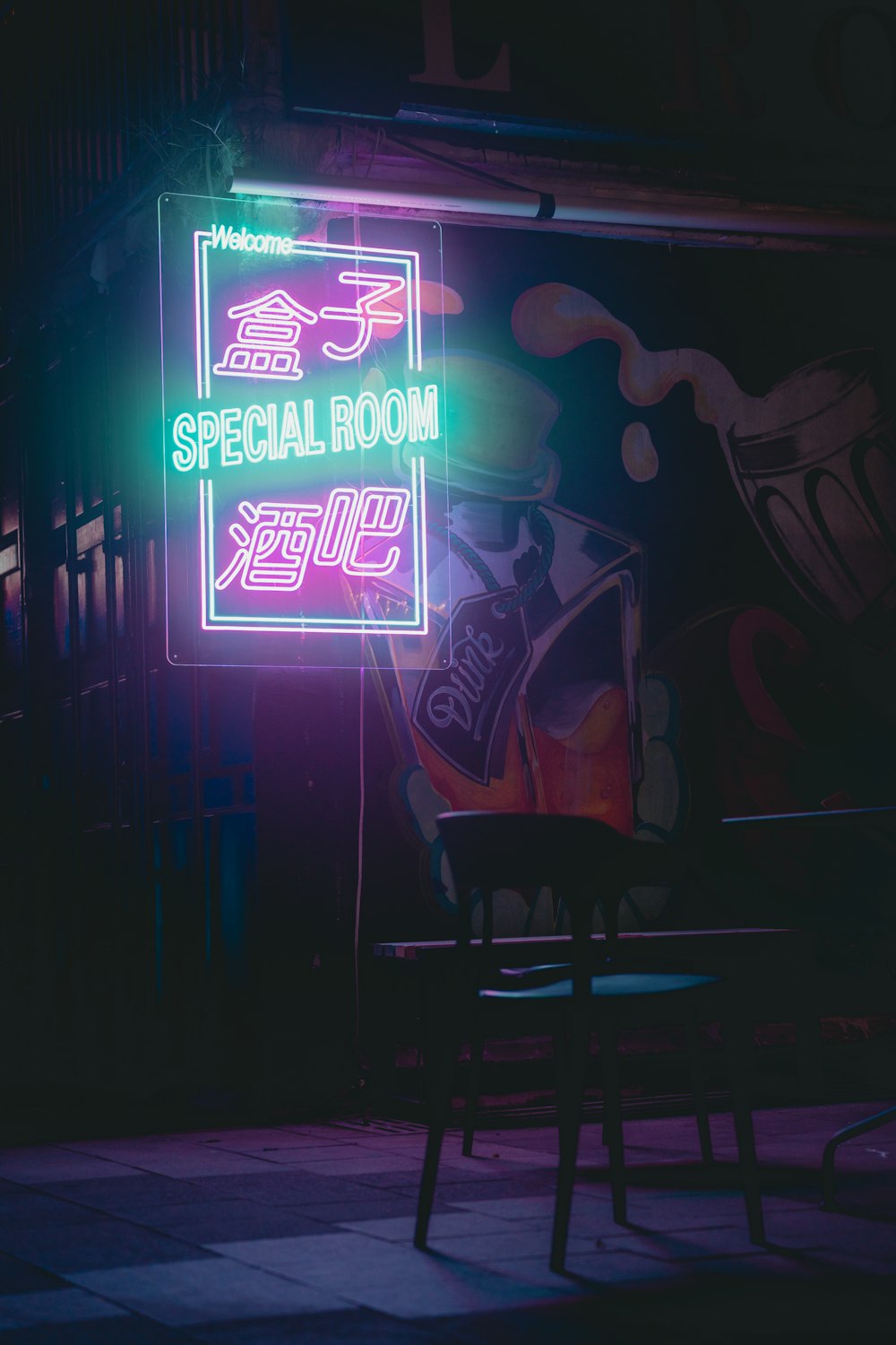 a neon sign with a chair in front of it
